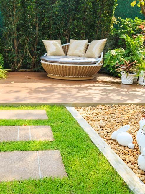 Landscaped garden patio with seating and stepping-stone path
